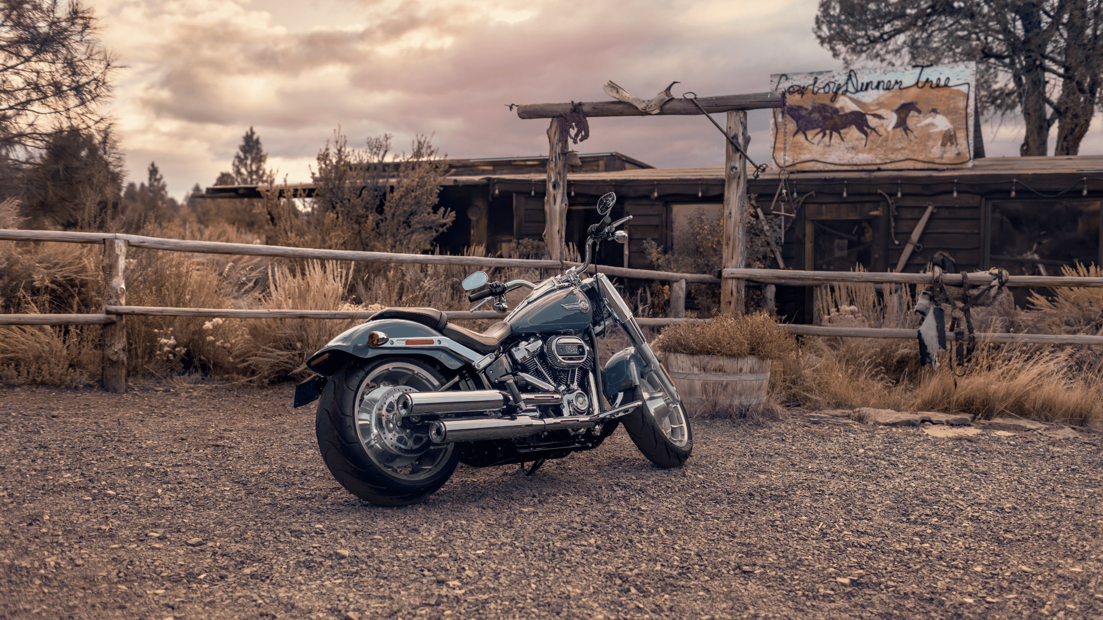 2024 Harley-Davidson® Fat Boy® 114 parked at a rustic ranch near Covington, GA, highlighting its classic design and powerful build.